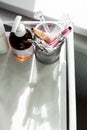 Part of the beautician table with cosmitic devices and care products. Top view, sunlight