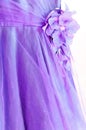 Part of beautiful lilac evening dress with  decorative fabric flower Royalty Free Stock Photo