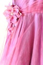 Part of beautiful pink dress with decorative flower Royalty Free Stock Photo