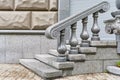 Part of a beautiful staircase in the city. Marble steps and handrails on the stairs. A fragment of the urban landscape