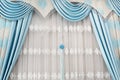 Part of beautifully draped curtain on the window in the room. Close up of curtain drapery with pendants. Luxury curtain, home deco Royalty Free Stock Photo