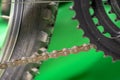 part of bicycle chain, tire and chainset teeth.  green background. Royalty Free Stock Photo