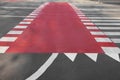 Part of bicycle lane painted red along pedestrian crossing on road Royalty Free Stock Photo