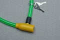 Part on a bicycle lock with a yellow metal core and a green plastic cable Royalty Free Stock Photo