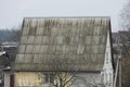 Part of a big rural house with a gray slate roof Royalty Free Stock Photo