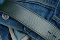 Part of a black leather belt on a blue cotton fabric Royalty Free Stock Photo