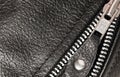 Part black leather clothing with a zipper. macro