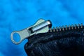 Part of a black leather with a gray metal clasp on a blue background Royalty Free Stock Photo