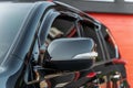 Part of the black modern car. Close-up rearview mirror. Exterior detail Royalty Free Stock Photo