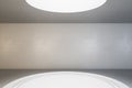 Part of blank white podium in empty hall room with concrete wall, floor and ceiling with big led light. Mockup Royalty Free Stock Photo