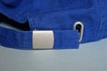 Part of a blue cap made of fabric with a metal fastener Royalty Free Stock Photo