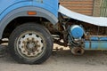 Part of an old truck with a big wheel in the sand Royalty Free Stock Photo