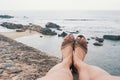 Part of body detail: woman lying on stone and looking on indian ocean in Galle