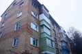 Part of a brick brown house with a number of balconies and windows against the sky Royalty Free Stock Photo