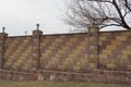 Part of a brown brick wall of a fence