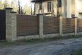 Part brown fence wall made of wooden boards