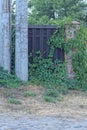 part of a brown fence wall made of wooden boards and bricks Royalty Free Stock Photo