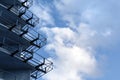Part of a building under construction. Fragment of concrete metal structures on a background of blue sky with clouds. Construction