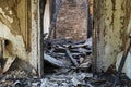 Part of a burnt destroyed room with an empty door frame