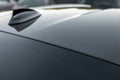 Part of carbon roof of the car. Modern design sport car radio antenna also known as shark fin. Close up carbon fibre car Royalty Free Stock Photo
