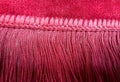 Part of the carpet with red yarn fringe. Here jute yarn has been dyed and used in fringe. The border of the carpet has been woven