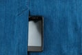 Part of cellphone in pocket of blue jeans Royalty Free Stock Photo