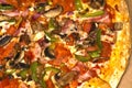 Part of the closeup pizza with mushrooms and bacon.