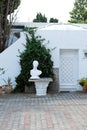 Part of cobbled streets of house decorated with flowers and greenery Royalty Free Stock Photo