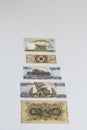 Part of collection of banknotes from the Asian region seen from the reverse side arranged on a white background