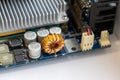 Part of a computer motherboard with capacitors, a transformer and a cooling radiator Royalty Free Stock Photo