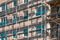 Part of construction site with scaffolding on multistory building facade during renovation Royalty Free Stock Photo