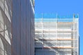 Part of construction site with scaffolding on multistory building facade during renovation Royalty Free Stock Photo