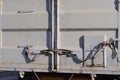 part of a container on a truck with gray closed metal doors with iron latches