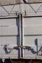 part of a container on a truck with gray closed metal doors