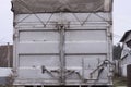 part of a container on a truck with gray closed metal doors