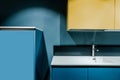 part of contemporary kitchen with blue and yellow shelves