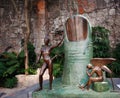 Part of a courtyard in Mexico with sculptures of a thumb and a man