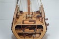 Part of cut wooden toy ship model with small details inside. Boat miniature on white background. Woodwork and hobby concept