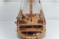 Part of cut wooden toy ship model with small details inside. Boat miniature on white background. Woodwork and hobby concept