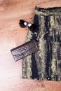 Part of dark skirt, purse, glasses