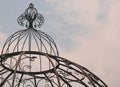 PART OF DECORATIVE METAL DOME AGAINST A CLOUDED SKY Royalty Free Stock Photo