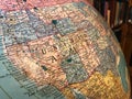 Part of the Earth globe with a political map on the background of books