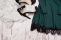 Part emerald dress with lace and black shoes on artificial fur, fashionable concept, space for text