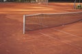 Part of empty clay tennis court with long net for play training Royalty Free Stock Photo