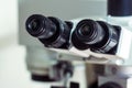 Part of the equipment for viewing small items. Black eyepieces of a professional laboratory microscope close-up. Royalty Free Stock Photo