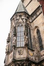 Part of the exterior of the beautiful old temple on the main square in Prague with black roof against gray sky