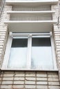 Part of the facade of the building with plastic spikes against pigeons. the design does not allow birds to sit down and shit. Vert Royalty Free Stock Photo