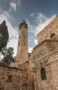 Part facade of the Church of the Holy Sepulchre and minaret of the mosque of Omar in Jerusalem