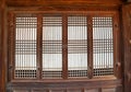 Part of the facade with a closed window of an ancient Korean palace building.