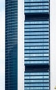 Part of the facades of an office building with concrete and blue honeycomb windows